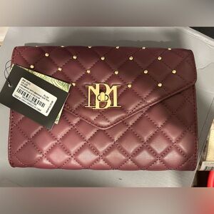 Brand new with tags. Cross body hand bag. Plumb color.